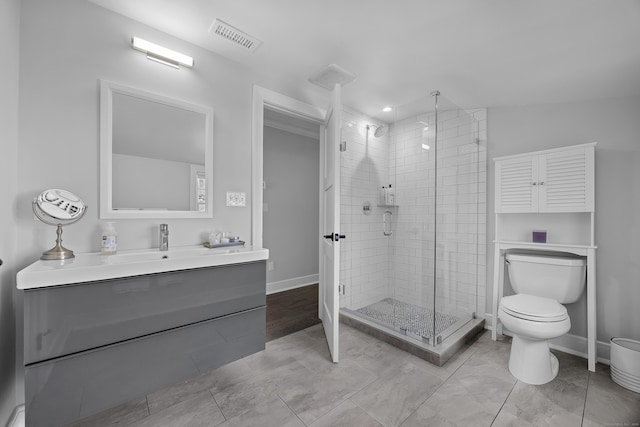 full bathroom featuring visible vents, a shower stall, toilet, and vanity