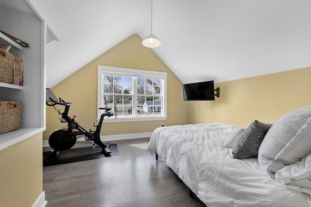 bedroom featuring baseboards, lofted ceiling, and wood finished floors