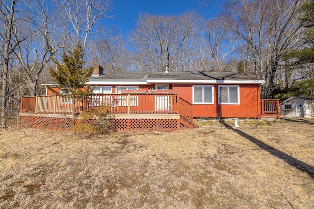 rear view of property featuring a wooden deck