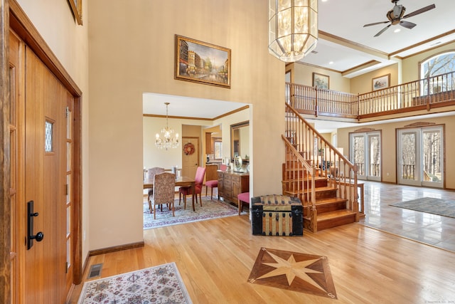 entrance foyer with stairway, a healthy amount of sunlight, and wood finished floors