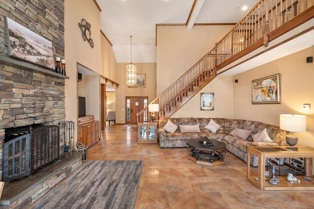 living area featuring stairway, a high ceiling, and a fireplace