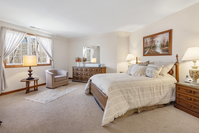 carpeted bedroom with visible vents and baseboards