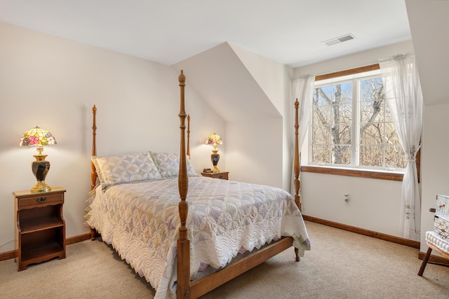 bedroom featuring visible vents, light colored carpet, and baseboards