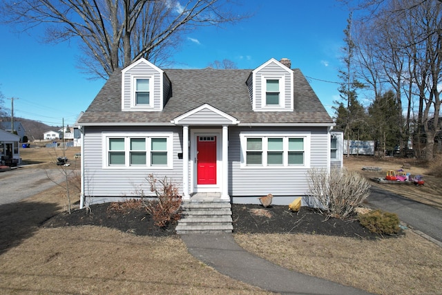 cape cod home with a shingled roof