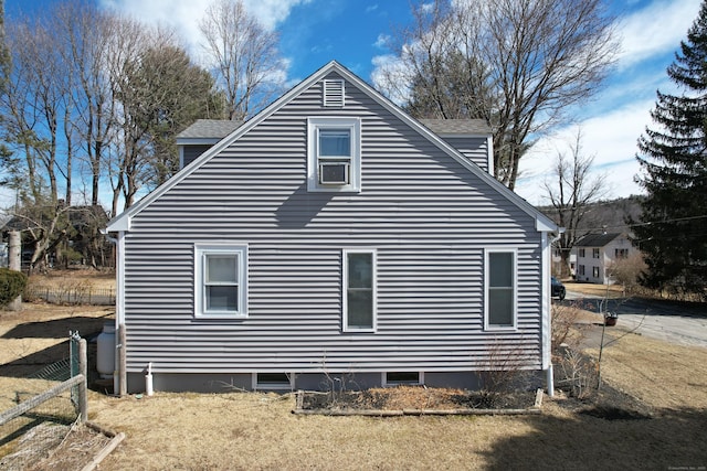 view of home's exterior with a shingled roof