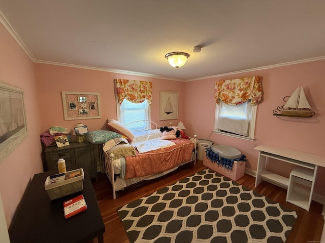 bedroom featuring crown molding and wood finished floors