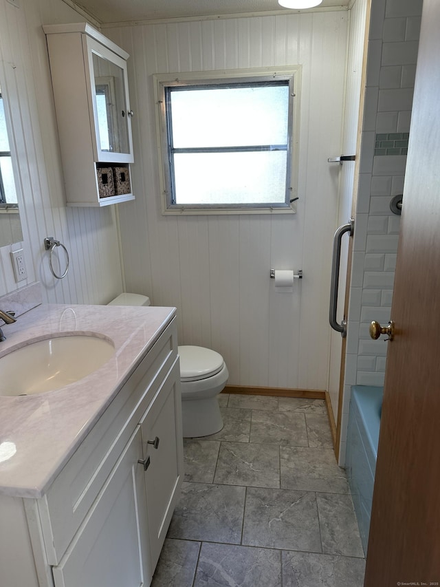 full bath with baseboards, toilet, and vanity