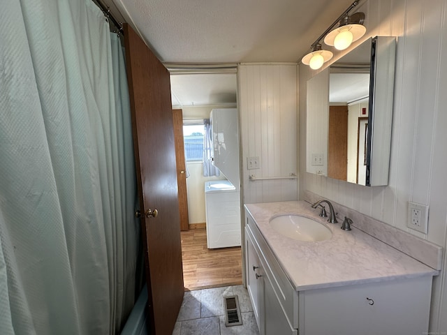 bathroom featuring visible vents, a textured ceiling, and vanity