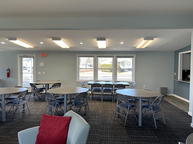 dining area with recessed lighting, a healthy amount of sunlight, baseboards, and dark colored carpet