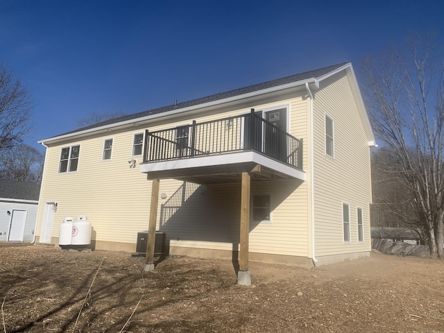 rear view of house featuring a carport and central AC unit