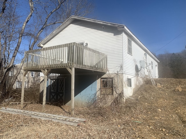 view of home's exterior with a wooden deck