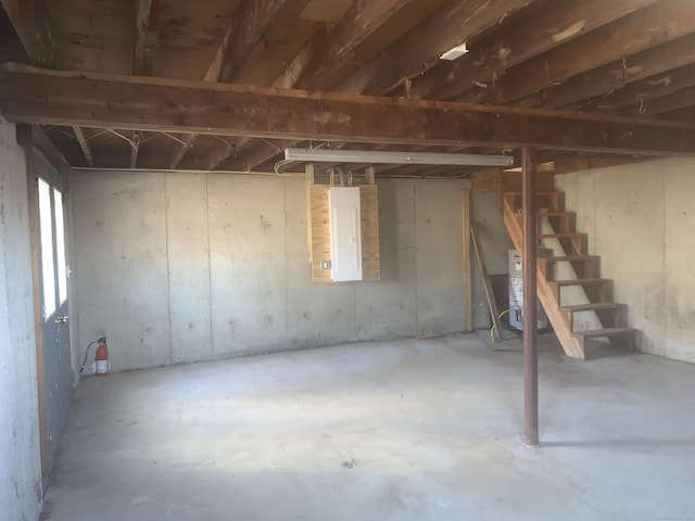 basement with stairs and water heater