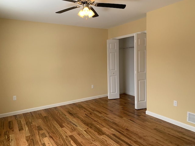 unfurnished bedroom featuring a closet, ceiling fan, baseboards, and wood finished floors