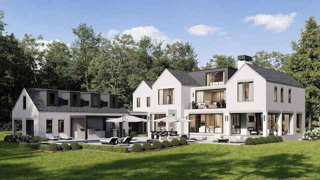 back of property featuring a patio area, a balcony, a lawn, and an outdoor pool