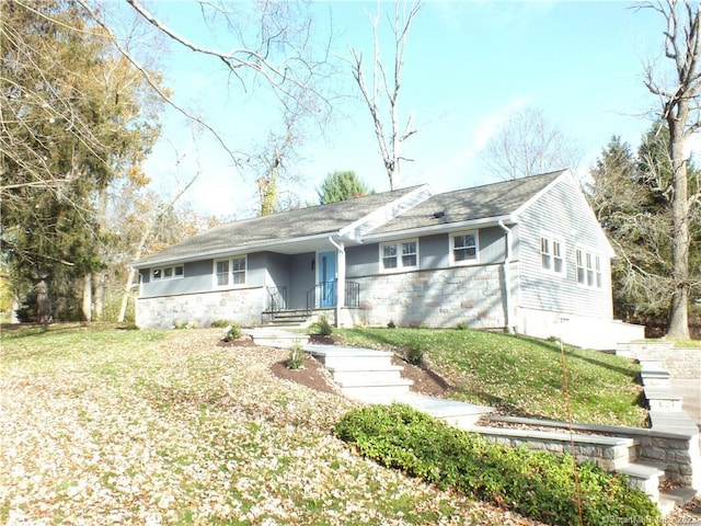 ranch-style house featuring stone siding