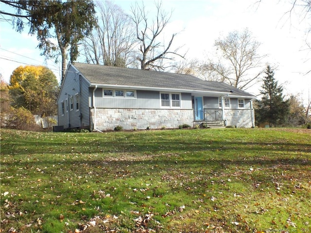 ranch-style home with stone siding and a front yard