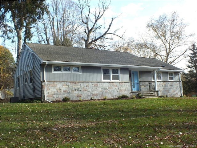 single story home with a front lawn, stone siding, and a shingled roof