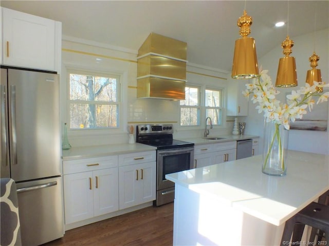 kitchen featuring custom range hood, white cabinets, appliances with stainless steel finishes, and a sink