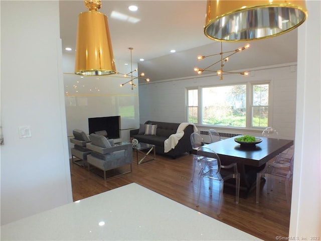 dining area featuring an inviting chandelier, radiator heating unit, wood finished floors, and recessed lighting