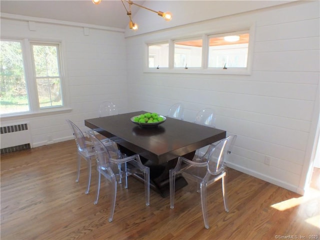 dining room with light wood finished floors and radiator heating unit