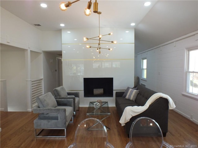 living area with visible vents, wood finished floors, recessed lighting, a fireplace, and a chandelier