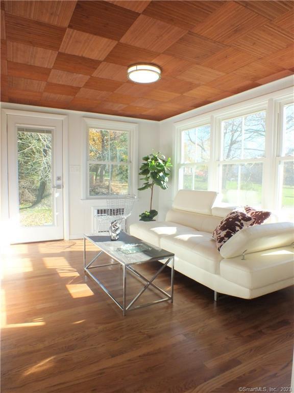 sunroom / solarium with a wealth of natural light and wood ceiling