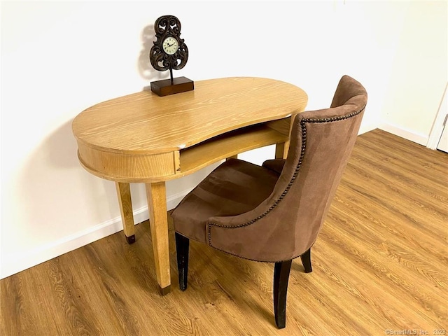 dining room with light wood finished floors and baseboards