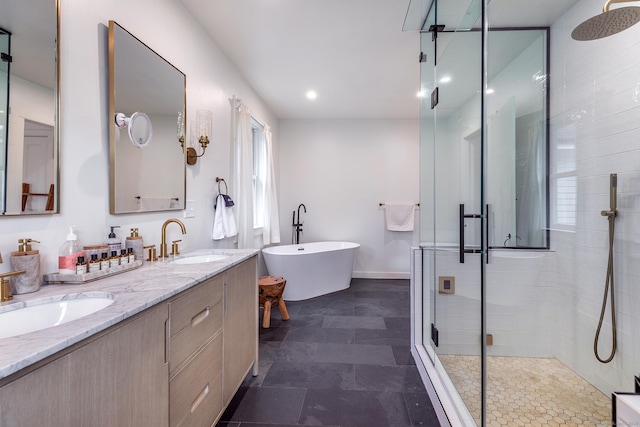 full bath with a stall shower, a freestanding bath, double vanity, and a sink