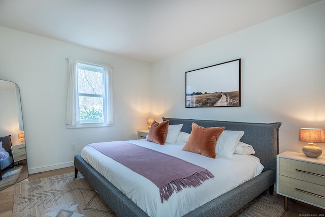 bedroom featuring wood finished floors and baseboards