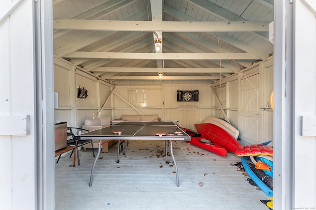 recreation room with wood finished floors and lofted ceiling with beams