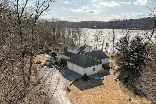 bird's eye view with a wooded view