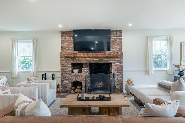 56 Mount Tom Passway Passway, Morris, CT 06763 - living area with a brick fireplace, recessed lighting, a decorative wall, and wainscoting