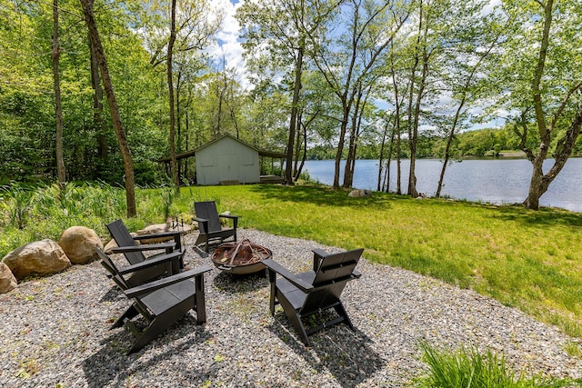 56 Mount Tom Passway Passway, Morris, CT 06763 - view of green lawn with a fire pit, a water view, and an outdoor structure