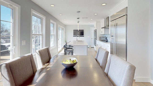 dining room with recessed lighting, light wood-style flooring, and a toaster