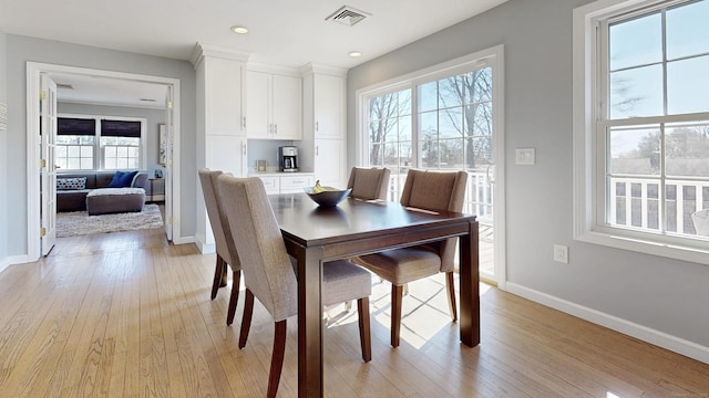 dining room with recessed lighting, baseboards, visible vents, and light wood finished floors