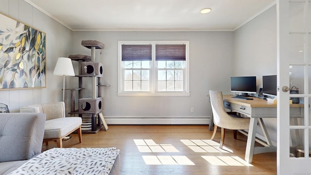 office space featuring baseboard heating, crown molding, and wood finished floors