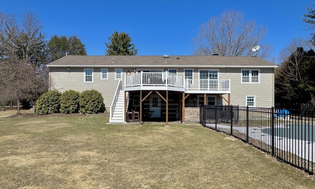 back of house with fence, stairs, a lawn, a deck, and a patio area