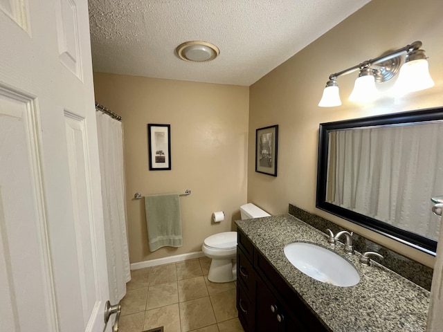 bathroom with tile patterned floors, toilet, a textured ceiling, and vanity