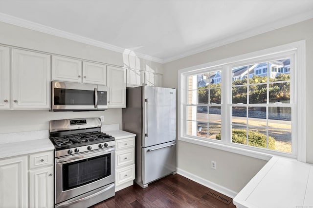 kitchen with visible vents, stainless steel appliances, light countertops, dark wood-type flooring, and crown molding