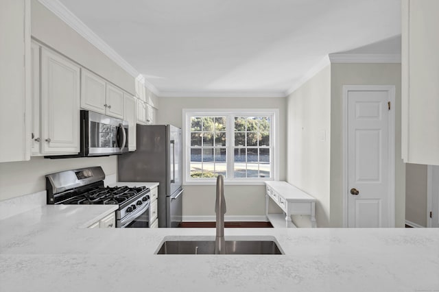 kitchen featuring crown molding, a sink, stainless steel appliances, white cabinetry, and light stone countertops