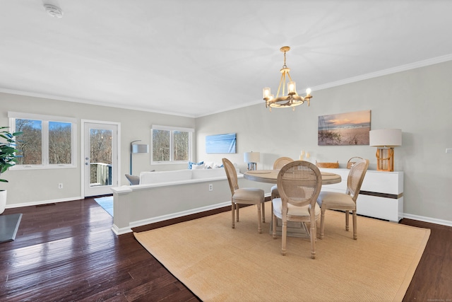 dining space featuring dark wood-type flooring, a notable chandelier, crown molding, and baseboards