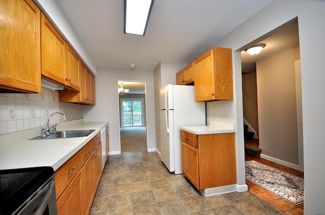 kitchen with white appliances, baseboards, a sink, light countertops, and tasteful backsplash