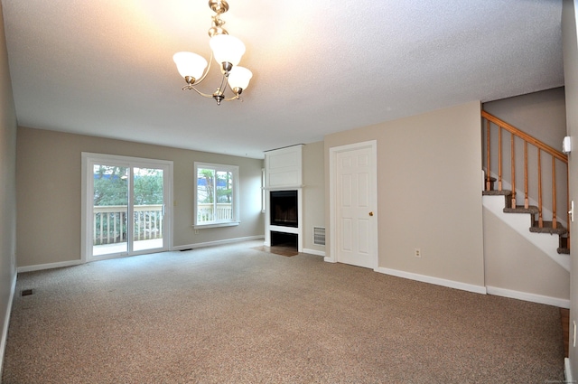 unfurnished living room featuring stairway, baseboards, and carpet