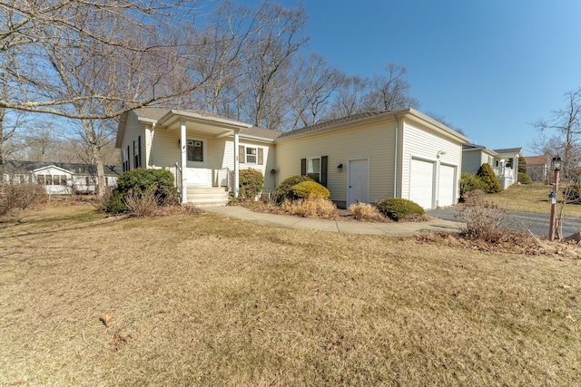 view of front of property with a front yard and a garage