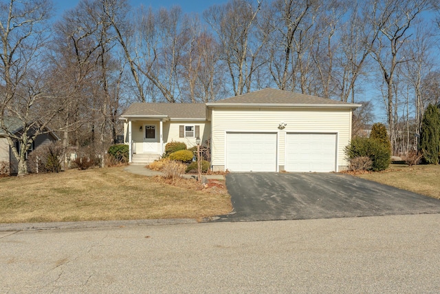 single story home with aphalt driveway, a garage, and a front lawn