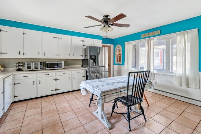 kitchen featuring light tile patterned floors, stainless steel appliances, white cabinetry, and light countertops