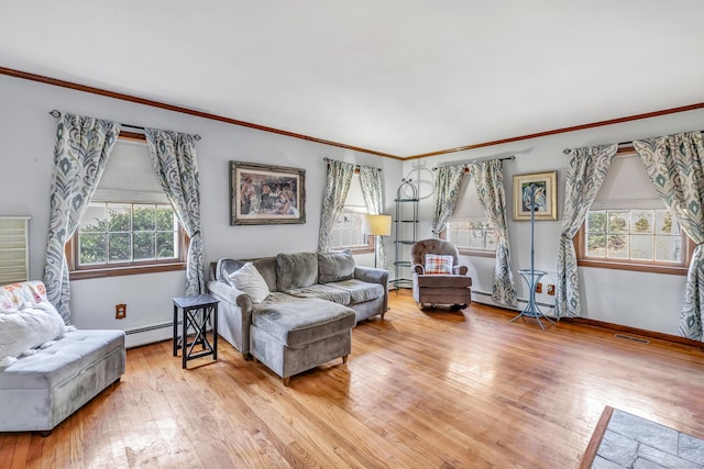 living room with visible vents, ornamental molding, hardwood / wood-style flooring, a baseboard radiator, and baseboards