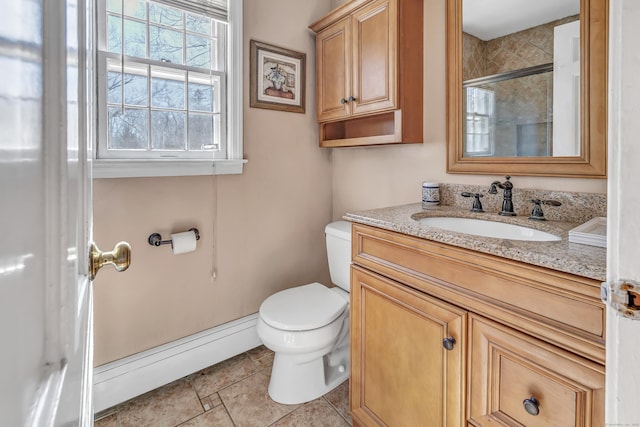 bathroom with vanity, toilet, baseboards, and a baseboard radiator