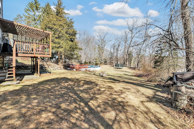 view of yard with stairway, a pergola, and a wooden deck