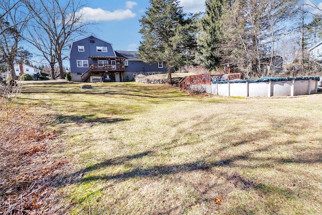 view of yard with an outdoor pool, a deck, and stairs